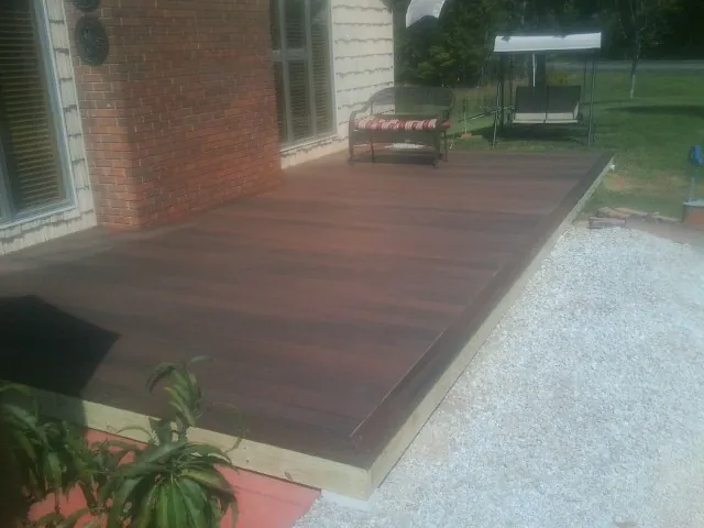 Freshly stained wood deck built against a brick home in Youngtown
