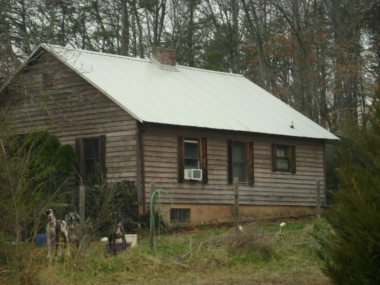 White metal roof on an old wood sided farmhouse, from a Metal Roof Installation job in Youngtown